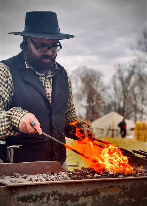 Brando working the forge at a living history event